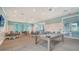Bright and airy game room with a pool table, seating area, and views of the community at 10186 Crystal Isle Cir, Sarasota, FL 34241