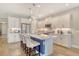 This kitchen features white cabinets, stainless steel appliances, a large island, and elegant pendant lighting at 10186 Crystal Isle Cir, Sarasota, FL 34241
