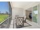 Charming screened lanai with slider to the great room, featuring a cozy seating area to enjoy the outdoors at 10186 Crystal Isle Cir, Sarasota, FL 34241