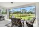 Relaxing screened lanai with comfortable seating, offering serene views of the natural surroundings at 10186 Crystal Isle Cir, Sarasota, FL 34241