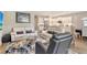 Inviting living room with neutral walls, hardwood floors, modern furniture, and an open connection to the kitchen at 10186 Crystal Isle Cir, Sarasota, FL 34241