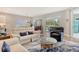 Spacious living room includes hardwood floors, modern furniture, sliding glass doors, and a view of the screened lanai at 10186 Crystal Isle Cir, Sarasota, FL 34241