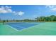 Spend time on one of the community's tennis courts for recreation, surrounded by lush green landscaping at 10186 Crystal Isle Cir, Sarasota, FL 34241