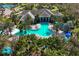 Stunning aerial view of community clubhouse with unique pool and tropical landscaping at 11435 Fort Lauderdale Pl, Venice, FL 34293