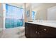 Bathroom featuring a shower with a unique curtain, dark cabinets and modern finishes at 11435 Fort Lauderdale Pl, Venice, FL 34293