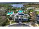 Aerial view of the community center overlooking the lake and pools; lush landscaping with palm trees at 11435 Fort Lauderdale Pl, Venice, FL 34293