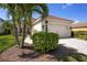 This lovely home features a two-car garage, landscaped yard, and a tile roof at 11435 Fort Lauderdale Pl, Venice, FL 34293
