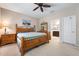 Comfortable main bedroom with ceiling fan, ensuite bathroom access, and neutral decor at 11435 Fort Lauderdale Pl, Venice, FL 34293