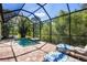 Comfortable seating near screened pool area overlooking mature landscaping at 11435 Fort Lauderdale Pl, Venice, FL 34293