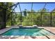 Inviting screened-in pool area with a peaceful view of the lush landscaping at 11435 Fort Lauderdale Pl, Venice, FL 34293