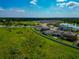 An aerial view of the community, showcasing the serene pond and lush green spaces surrounding the homes at 12613 Oak Hill Way, Parrish, FL 34219
