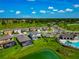 Aerial view of community featuring lush greenery, community pool, and well-maintained homes at 12613 Oak Hill Way, Parrish, FL 34219