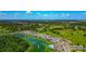 An aerial view of a Primary planned community with a view of the lake and recreation center at 12613 Oak Hill Way, Parrish, FL 34219