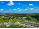 An aerial view of the community showing the homes, pool, and surrounding landscape at 12613 Oak Hill Way, Parrish, FL 34219