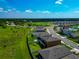 An aerial view of a residential community with green spaces and modern homes at 12613 Oak Hill Way, Parrish, FL 34219