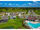 Aerial view of a community with homes, a lake, a pool, and green fields at 12613 Oak Hill Way, Parrish, FL 34219