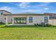 Spacious backyard with lush lawn, covered patio, and rear home elevation, perfect for outdoor living and entertaining at 12613 Oak Hill Way, Parrish, FL 34219