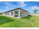 Lush backyard with green lawn, covered patio, and exterior elevation, a private outdoor retreat at 12613 Oak Hill Way, Parrish, FL 34219