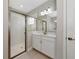 Bathroom boasts a glass shower, white vanity, tile floors, and a large mirror at 12613 Oak Hill Way, Parrish, FL 34219