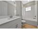 Bathroom featuring a white vanity, tile backsplash, and a shower-tub combo with curtain and wood-look floors at 12613 Oak Hill Way, Parrish, FL 34219