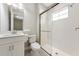 Bright bathroom featuring a modern vanity, toilet, and a glass-enclosed walk-in shower with white tile at 12613 Oak Hill Way, Parrish, FL 34219