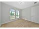 Neutral bedroom with carpet, light walls, decorative lighting, and two arched windows allowing for natural light at 12613 Oak Hill Way, Parrish, FL 34219