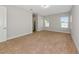 Spacious bedroom with plush carpeting, neutral walls, and natural light from the windows at 12613 Oak Hill Way, Parrish, FL 34219