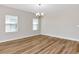 Bright dining room featuring wood flooring, neutral paint, and two windows with blinds at 12613 Oak Hill Way, Parrish, FL 34219