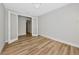 A versatile empty room with light wood flooring, a chandelier and an open doorway at 12613 Oak Hill Way, Parrish, FL 34219