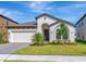 Charming single-story home with a well-manicured lawn and an attached two-car garage at 12613 Oak Hill Way, Parrish, FL 34219