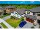 Beautiful two-story home featuring a well-manicured lawn, paver driveway, and an attached two-car garage at 12613 Oak Hill Way, Parrish, FL 34219