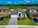 Charming home featuring a well-manicured lawn, paver driveway and attached two car garage at 12613 Oak Hill Way, Parrish, FL 34219