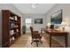 Well-appointed home office with custom bookcase, elegant desk, and decor at 12613 Oak Hill Way, Parrish, FL 34219