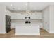 Bright kitchen featuring white cabinetry, stainless appliances, quartz countertops, and modern lighting at 12613 Oak Hill Way, Parrish, FL 34219
