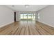Bright living room featuring wood flooring, a modern chandelier, and sliding glass doors to the backyard at 12613 Oak Hill Way, Parrish, FL 34219