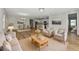 Open-concept living space with modern furnishings, light wood floors, and neutral decor at 12613 Oak Hill Way, Parrish, FL 34219