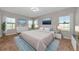 Serene primary bedroom boasts natural light, neutral colors, and stylish furnishings at 12613 Oak Hill Way, Parrish, FL 34219