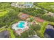 Aerial view of community with swimming pool, playground, tennis courts, and lake for recreation at 12642 Cara Cara Loop, Bradenton, FL 34212