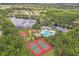 Overhead view of the community amenities: pool, tennis & basketball courts, and playground near a pond at 12642 Cara Cara Loop, Bradenton, FL 34212