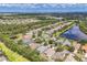 Expansive aerial shot displaying a house in a community with lake views and verdant landscapes at 12642 Cara Cara Loop, Bradenton, FL 34212