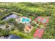 Community amenities including swimming pool, playground, and tennis courts beside a scenic pond at 12642 Cara Cara Loop, Bradenton, FL 34212
