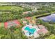 Community pool and recreational area with tennis courts and playground overlooking the lake at 12642 Cara Cara Loop, Bradenton, FL 34212