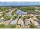 Scenic aerial perspective featuring a house in a picturesque community with a lake and mature trees at 12642 Cara Cara Loop, Bradenton, FL 34212
