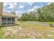 Backyard featuring a white picket fence and mature trees, providing privacy and charm at 12642 Cara Cara Loop, Bradenton, FL 34212