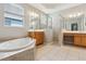 Spacious bathroom featuring double sinks, a soaking tub, and a walk-in shower at 12642 Cara Cara Loop, Bradenton, FL 34212