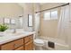 Well-lit bathroom featuring a shower-tub combo, white sink, and wood cabinets at 12642 Cara Cara Loop, Bradenton, FL 34212