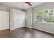 Bright bedroom with hardwood floors, neutral paint, and a ceiling fan, with ample closet space at 12642 Cara Cara Loop, Bradenton, FL 34212