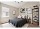 Charming bedroom featuring a cozy bed, decorative wall art, and natural light from the window at 12642 Cara Cara Loop, Bradenton, FL 34212