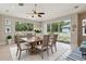 Bright dining room featuring an elegant wooden table, neutral walls, and sliding glass doors at 12642 Cara Cara Loop, Bradenton, FL 34212