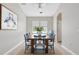Formal dining room with bright natural light, elegant decor, and a modern ceiling fan at 12642 Cara Cara Loop, Bradenton, FL 34212